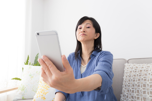 Woman with long sight holding phone