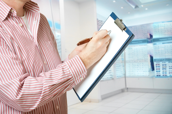 Man writing on clipboard