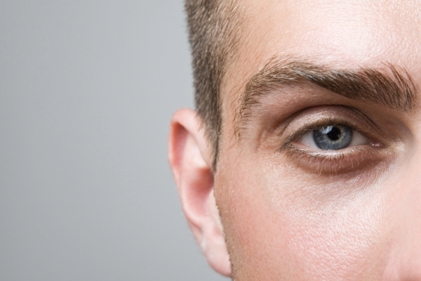 Close-up of a man's eye and eyelashes